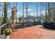 Cozy deck offers wood flooring and shade umbrella with pretty garden background at 708 Larkspur Nw Blvd, Acworth, GA 30102