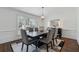 Elegant dining room with a dark wood table, soft gray chairs, and large window for natural light at 708 Larkspur Nw Blvd, Acworth, GA 30102