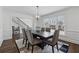 Beautiful dining area with an overhead light fixture, six chairs, and hardwood flooring at 708 Larkspur Nw Blvd, Acworth, GA 30102