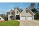 Attractive home with a well-maintained lawn, double garage and appealing architectural details at 708 Larkspur Nw Blvd, Acworth, GA 30102