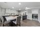 Modern kitchen with marble countertops and cabinets, dining table, and adjacent laundry area at 708 Larkspur Nw Blvd, Acworth, GA 30102