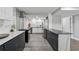 Well-lit kitchen with black marble island, white cabinets, and stainless steel appliances, perfect for cooking at 708 Larkspur Nw Blvd, Acworth, GA 30102