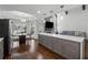 Open kitchen and dining area with gray cabinets, a large island, and a view of the fireplace at 708 Larkspur Nw Blvd, Acworth, GA 30102