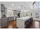 Modern kitchen with gray cabinets, stainless steel appliances, and a large center island with bar stool seating at 708 Larkspur Nw Blvd, Acworth, GA 30102