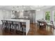 Stylish kitchen with stainless steel appliances, a large center island with bar stools, and an adjacent breakfast nook at 708 Larkspur Nw Blvd, Acworth, GA 30102