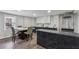 Bright kitchen with modern white and black marble countertops, stainless steel range hood and dining table at 708 Larkspur Nw Blvd, Acworth, GA 30102
