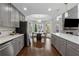 Contemporary kitchen with gray cabinets, stainless appliances, and a dining area at 708 Larkspur Nw Blvd, Acworth, GA 30102