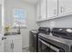 Well-lit laundry room with modern washer and dryer units at 708 Larkspur Nw Blvd, Acworth, GA 30102