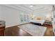 Tranquil main bedroom featuring tray ceilings, a ceiling fan, and hardwood floors at 708 Larkspur Nw Blvd, Acworth, GA 30102