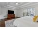 Bright main bedroom with tray ceilings, large windows, and dark hardwood floors at 708 Larkspur Nw Blvd, Acworth, GA 30102
