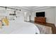 Bright main bedroom featuring an ensuite bath with a sliding barn door and a large TV at 708 Larkspur Nw Blvd, Acworth, GA 30102