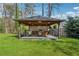 Perfect outdoor kitchen features dining space, grill, and stone countertop for entertaining in the landscaped yard at 708 Larkspur Nw Blvd, Acworth, GA 30102