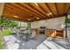 Attractive outdoor kitchen provides dining space, wood ceiling, and built-in grill perfect for entertaining at 708 Larkspur Nw Blvd, Acworth, GA 30102