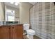 Bathroom featuring a vanity with granite countertop, toilet and patterned shower curtain at 1952 Appaloosa Mill Cir, Buford, GA 30519