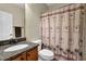 Bathroom with sink, toilet, and shower with tropical themed curtain at 1952 Appaloosa Mill Cir, Buford, GA 30519