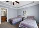 Bedroom featuring two twin beds, with an open door to a bathroom at 1952 Appaloosa Mill Cir, Buford, GA 30519