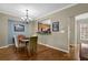Bright dining room with hardwood floors and a view into the kitchen area, perfect for entertaining and Gathering meals at 1952 Appaloosa Mill Cir, Buford, GA 30519