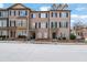 Charming brick townhome featuring black shutters and well-maintained landscaping at 1952 Appaloosa Mill Cir, Buford, GA 30519