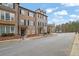 Inviting brick townhome with a covered entrance and manicured front yard at 1952 Appaloosa Mill Cir, Buford, GA 30519