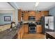 Well-equipped kitchen with stainless steel appliances, granite countertops, and ample cabinet space for storage at 1952 Appaloosa Mill Cir, Buford, GA 30519