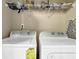 Laundry room with a washer and dryer, with shelving above for storage at 1952 Appaloosa Mill Cir, Buford, GA 30519