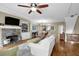Cozy living room with a stone fireplace and built-in bookshelves at 1952 Appaloosa Mill Cir, Buford, GA 30519