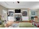 Inviting living room with a fireplace, built-in shelves, and hardwood floors at 1952 Appaloosa Mill Cir, Buford, GA 30519