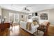 Bright, open-concept living room with a ceiling fan and hardwood flooring at 1952 Appaloosa Mill Cir, Buford, GA 30519