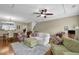 Well-lit living room with hardwood floors, comfortable seating, and an open floor plan at 1952 Appaloosa Mill Cir, Buford, GA 30519