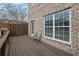 Outdoor patio with a wooden deck, chairs, and brick exterior at 1952 Appaloosa Mill Cir, Buford, GA 30519