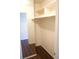 This is a closet with wooden floors and white shelves for organizing clothes and storage at 2211 Surrey Se Ct, Marietta, GA 30067