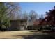 This is an exterior shot of a two-story house surrounded by trees and a lawn at 2211 Surrey Se Ct, Marietta, GA 30067