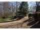 Two-story home with neutral siding, mature trees, and a hillside yard, offering a serene and private setting at 2211 Surrey Se Ct, Marietta, GA 30067