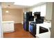 A bright kitchen is featured with a skylight, white cabinetry and black appliances and wood floor at 2211 Surrey Se Ct, Marietta, GA 30067