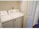 This is a laundry room with two washing machines and a door for privacy at 2211 Surrey Se Ct, Marietta, GA 30067
