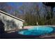 This is an inground pool for residents with trees and a building nearby at 2211 Surrey Se Ct, Marietta, GA 30067