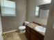 Bathroom with a single sink vanity, toilet, and a window providing natural light at 2938 Palm Dr, Atlanta, GA 30344
