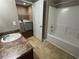 Functional bathroom featuring a shower-tub combo and convenient access to a laundry area at 2938 Palm Dr, Atlanta, GA 30344