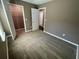 A spacious bedroom with neutral carpet and walls and an open closet at 2938 Palm Dr, Atlanta, GA 30344