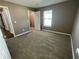 Bedroom featuring neutral carpet and walls with ample natural light from a nearby window at 2938 Palm Dr, Atlanta, GA 30344