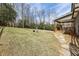 Expansive backyard with a covered back porch, stone pathway, and lush grass, perfect for outdoor enjoyment at 3878 Amicus Dr, Buford, GA 30519