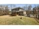 Expansive backyard featuring a wooden deck, stone walkway, and fenced basketball court at 3878 Amicus Dr, Buford, GA 30519