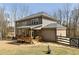 Backyard view of the home featuring a wooden deck and stone walkway at 3878 Amicus Dr, Buford, GA 30519