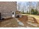 Brick-exterior home with a backyard featuring a stone pathway and steps to an outdoor entrance at 3878 Amicus Dr, Buford, GA 30519