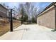 Basketball court and hoop in a backyard with a brick-exterior home in the background at 3878 Amicus Dr, Buford, GA 30519