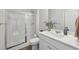 Bright bathroom features a glass-enclosed shower and a white vanity with a sleek countertop at 3878 Amicus Dr, Buford, GA 30519