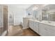 Bright bathroom featuring double vanity, separate bathtub and a glass-enclosed shower at 3878 Amicus Dr, Buford, GA 30519