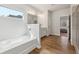 Light-filled bathroom featuring a soaking tub and separate shower with a ceramic tile surround at 3878 Amicus Dr, Buford, GA 30519