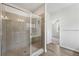 Bright bathroom featuring large glass enclosed shower with ceramic tile and wood look floors at 3878 Amicus Dr, Buford, GA 30519