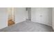 A bedroom is shown featuring multiple doors and light gray carpet at 3878 Amicus Dr, Buford, GA 30519